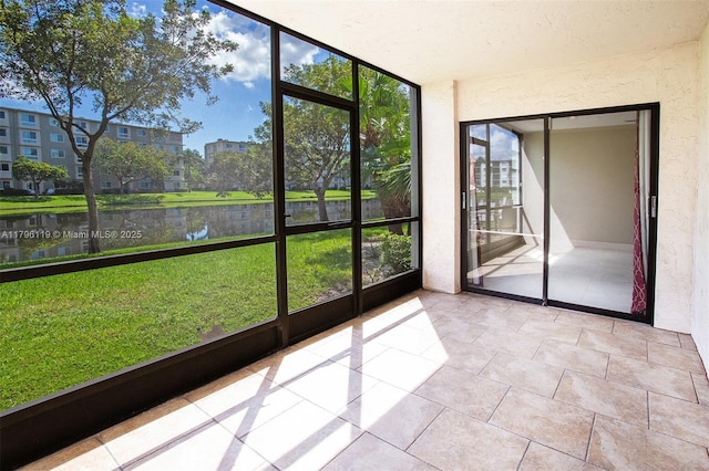 unfurnished sunroom with a water view