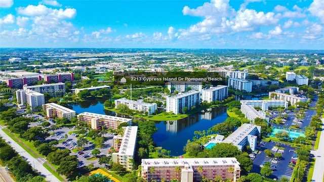 birds eye view of property with a city view and a water view