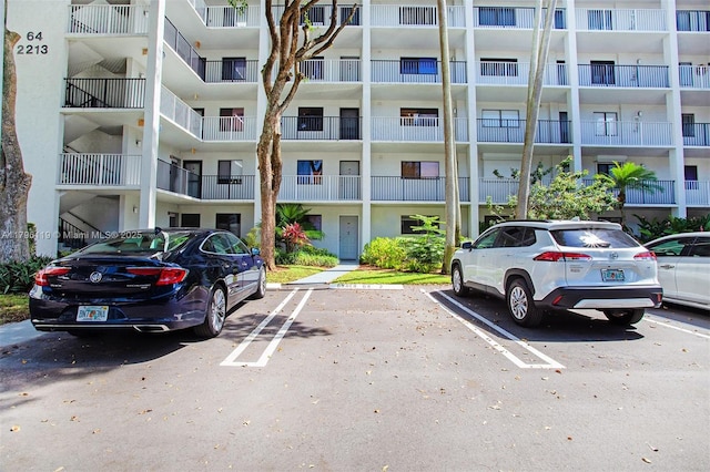 view of building exterior with uncovered parking