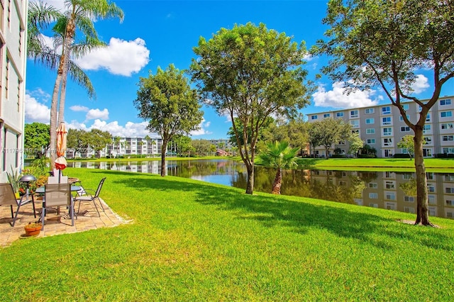 view of yard with a water view and a patio area