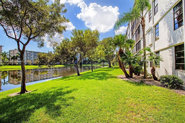 surrounding community featuring a yard and a water view