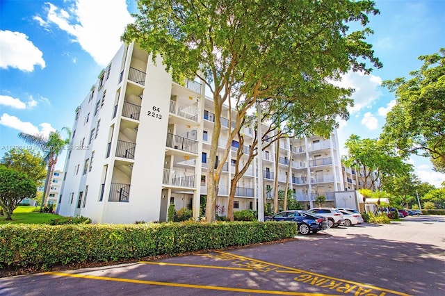 view of building exterior with uncovered parking