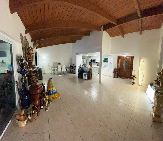 miscellaneous room featuring high vaulted ceiling, tile patterned floors, wooden ceiling, and beamed ceiling