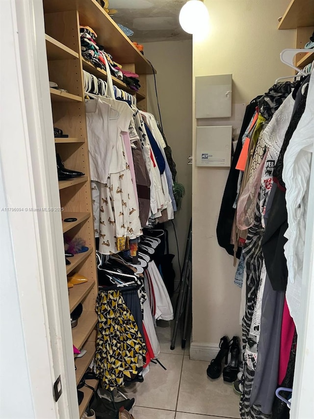 walk in closet with tile patterned floors