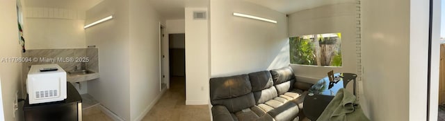 interior space with baseboards and visible vents