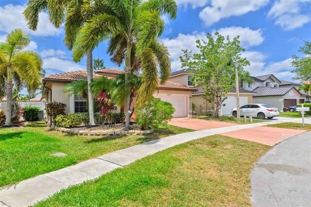 18271 SW 27th St, Miramar, FL 33029 - view of front of property with stucco siding, driveway, a garage, a front yard, and a tile roof