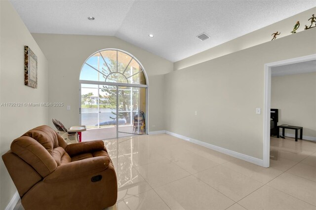 18271 SW 27th St, Miramar, FL 33029 - sitting room featuring vaulted ceiling, a textured ceiling, light tile patterned flooring, baseboards, and recessed lighting