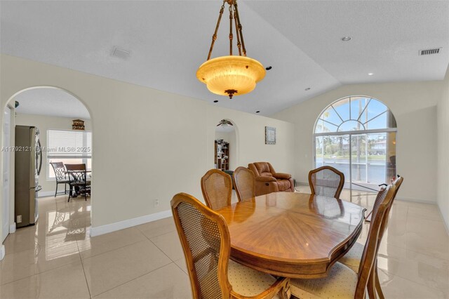 18271 SW 27th St, Miramar, FL 33029 - dining space featuring arched walkways, lofted ceiling, plenty of natural light, and light tile patterned floors
