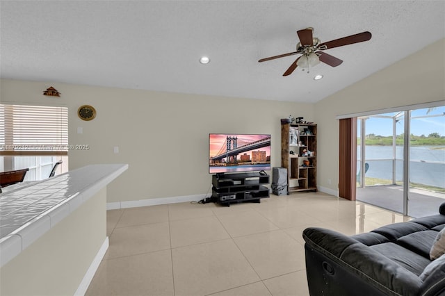 18271 SW 27th St, Miramar, FL 33029 - living room with baseboards, lofted ceiling, ceiling fan, light tile patterned flooring, and recessed lighting