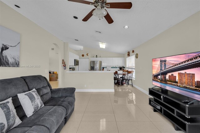 18271 SW 27th St, Miramar, FL 33029 - living area with lofted ceiling, a ceiling fan, arched walkways, baseboards, and light tile patterned floors