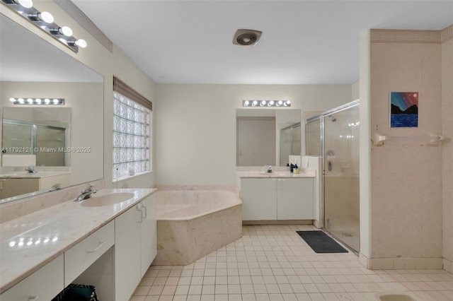18271 SW 27th St, Miramar, FL 33029 - full bathroom with two vanities, a garden tub, a stall shower, and tile patterned floors