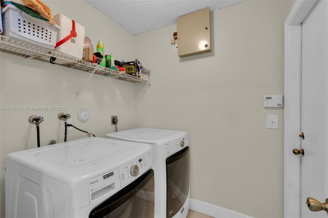 18271 SW 27th St, Miramar, FL 33029 - washroom featuring washing machine and clothes dryer, a textured ceiling, and baseboards