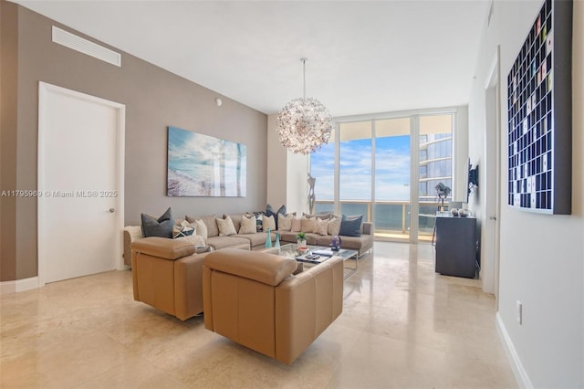 living room featuring visible vents, a chandelier, and a wall of windows