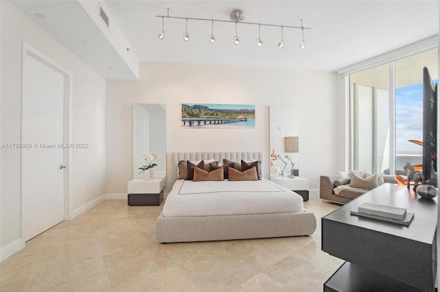 bedroom with light tile patterned flooring, baseboards, visible vents, and track lighting