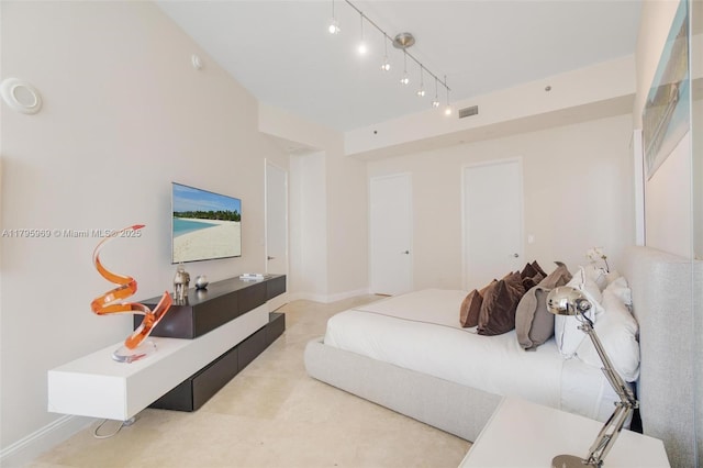bedroom featuring baseboards and visible vents