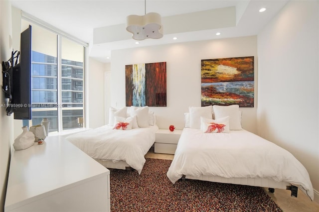 bedroom with recessed lighting and a wall of windows