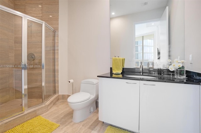 bathroom featuring visible vents, vanity, toilet, recessed lighting, and a shower stall