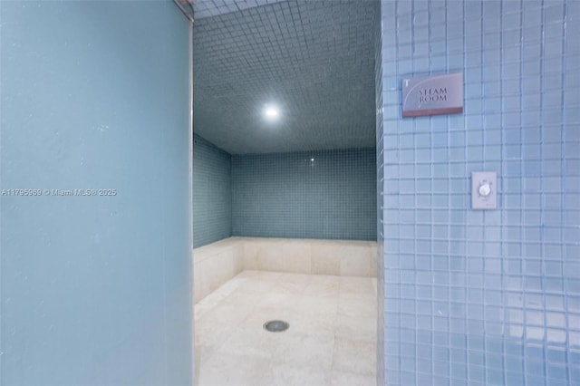 full bath with a tile shower