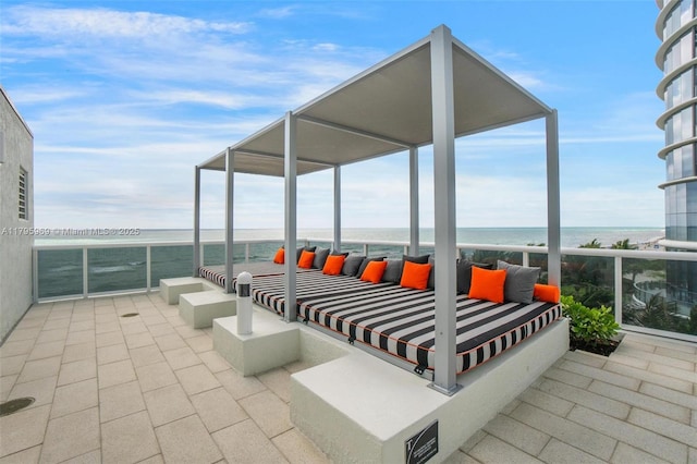 view of patio / terrace featuring a water view and a balcony