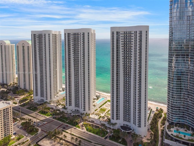 bird's eye view with a water view, a city view, and a beach view