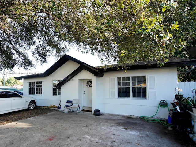 ranch-style home featuring a patio area and stucco siding