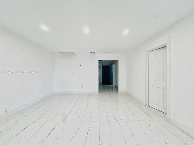 empty room with recessed lighting and baseboards