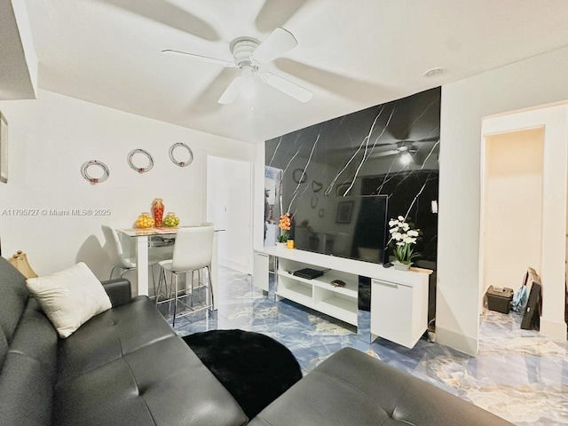 living room featuring ceiling fan and marble finish floor