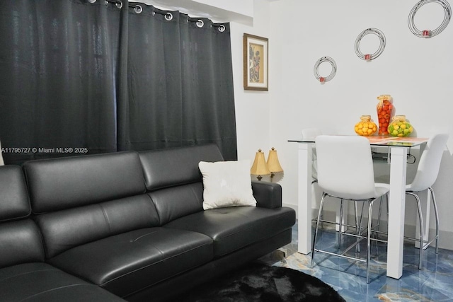 living room featuring baseboards and marble finish floor