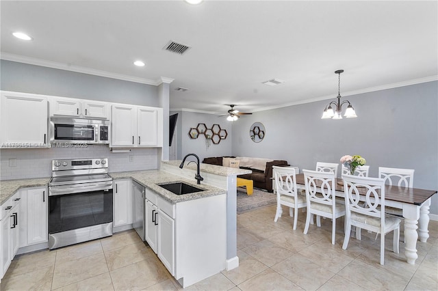kitchen with visible vents, ornamental molding, a peninsula, a sink, and stainless steel appliances