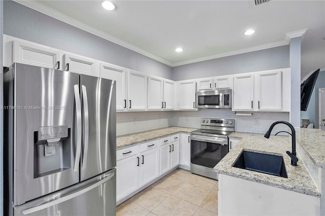 kitchen featuring a sink, appliances with stainless steel finishes, crown molding, and tasteful backsplash