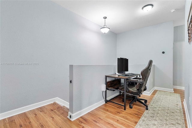 office area with light wood-type flooring and baseboards