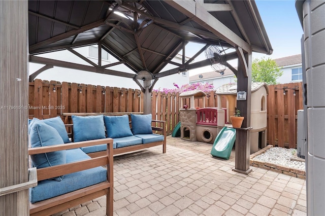 view of patio with a gazebo, an outdoor living space, and fence