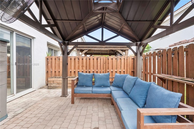 view of patio featuring a gazebo, fence, and an outdoor hangout area