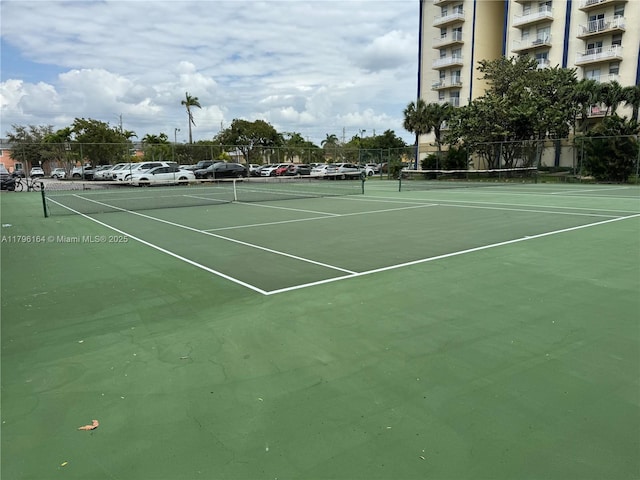 view of tennis court featuring fence
