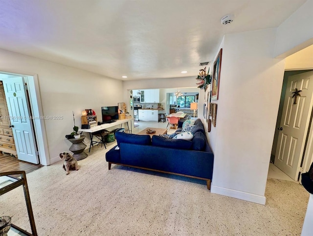 living room with baseboards, recessed lighting, and speckled floor