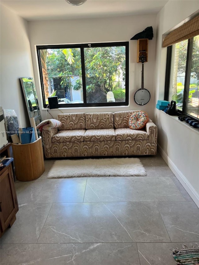 living room featuring plenty of natural light and baseboards