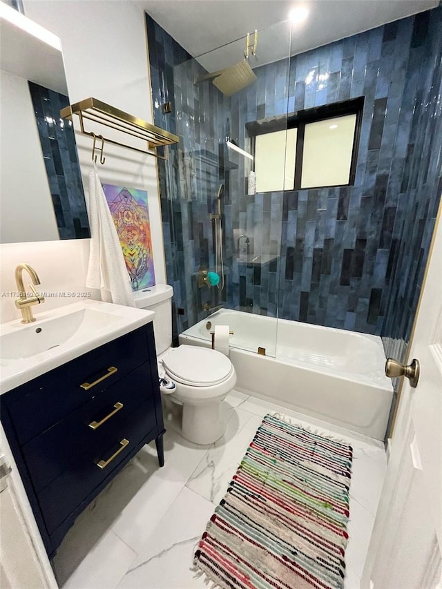 bathroom featuring toilet, shower / bathing tub combination, marble finish floor, and vanity