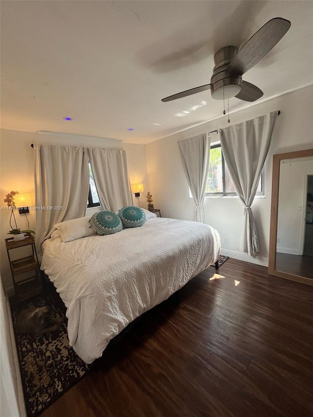 bedroom featuring baseboards, a ceiling fan, and wood finished floors