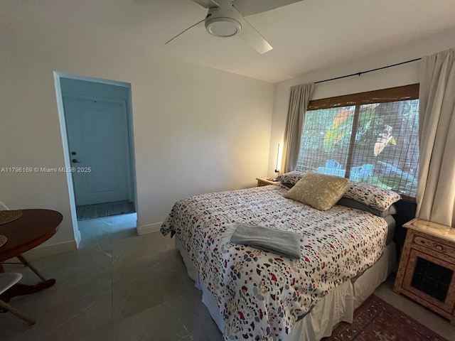 bedroom with tile patterned flooring, a ceiling fan, and baseboards