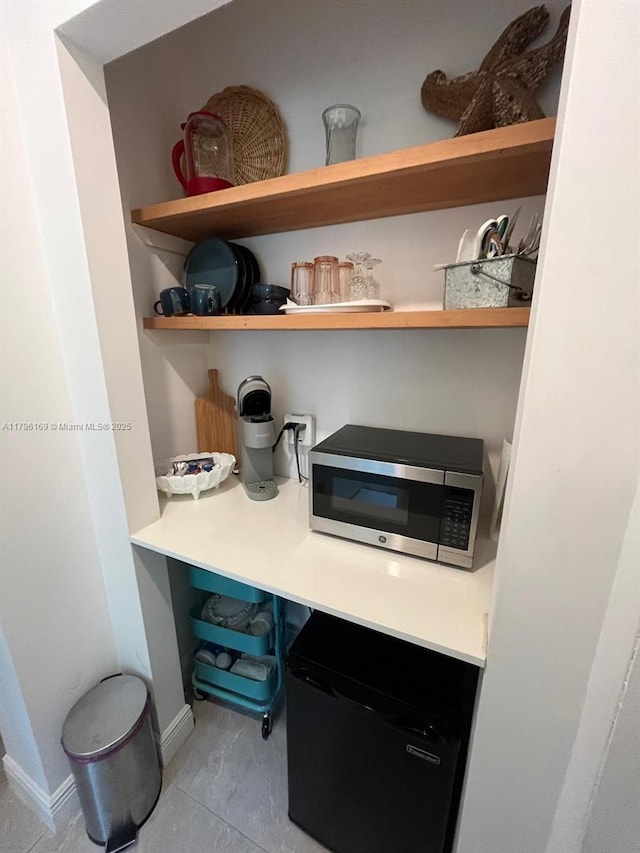 722 SW 10th St, Hallandale Beach, FL 33009 - detailed view of open shelves, stainless steel microwave, and refrigerator