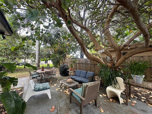 view of patio featuring an outdoor living space, outdoor dining area, and a fenced backyard