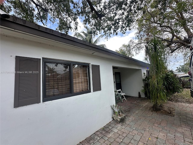 view of property exterior with a patio and stucco siding