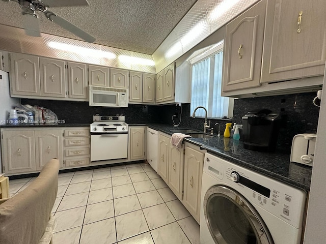 kitchen featuring a ceiling fan, backsplash, washer / clothes dryer, a sink, and white appliances