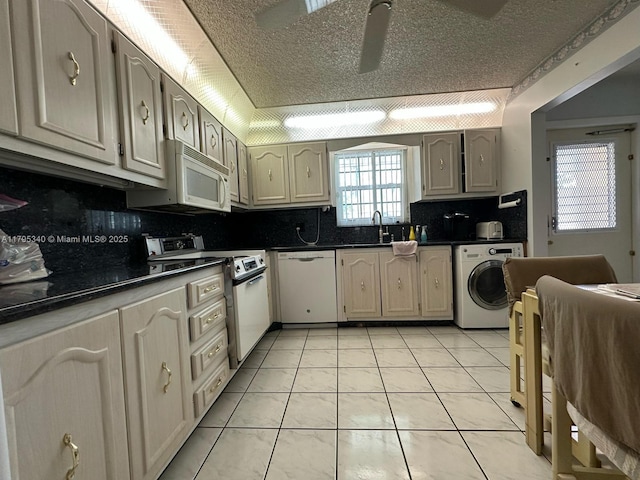 kitchen with washer / clothes dryer, dark countertops, decorative backsplash, and white appliances