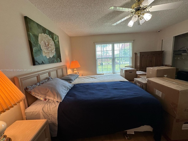bedroom featuring a textured ceiling and ceiling fan