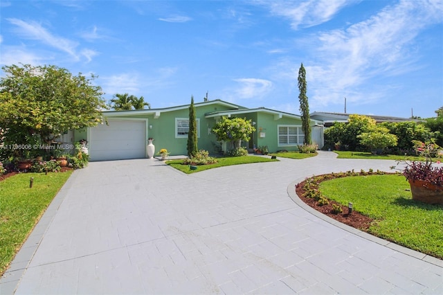 7691 NW 15th Ct, Pembroke Pines, FL 33024 - view of front of home with curved driveway, stucco siding, an attached garage, and a front lawn