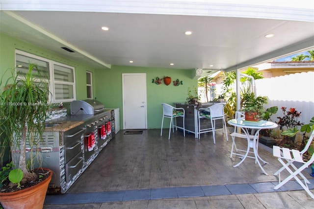 7691 NW 15th Ct, Pembroke Pines, FL 33024 - view of patio featuring exterior kitchen, fence, and outdoor dining area
