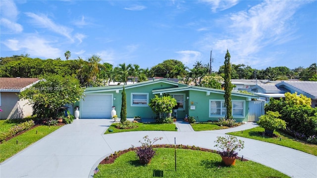 7691 NW 15th Ct, Pembroke Pines, FL 33024 - view of front of house featuring curved driveway, a garage, a front yard, and stucco siding