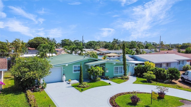 7691 NW 15th Ct, Pembroke Pines, FL 33024 - ranch-style home featuring curved driveway, a garage, stucco siding, a residential view, and a front yard