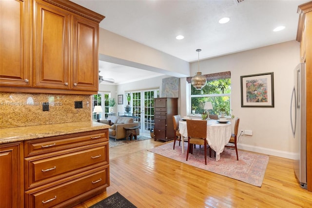dining room featuring recessed lighting, baseboards, and light wood finished floors